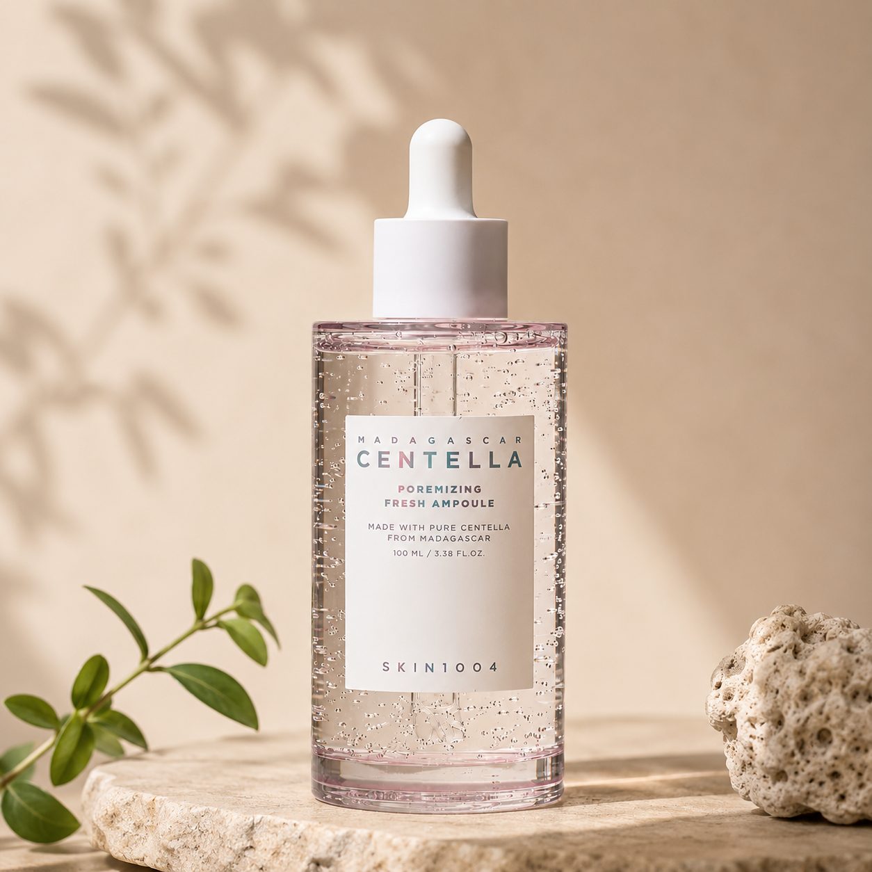 The bottle on stone with a sprig of greenery